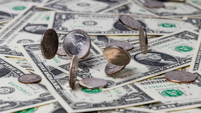 coins on pile of cash